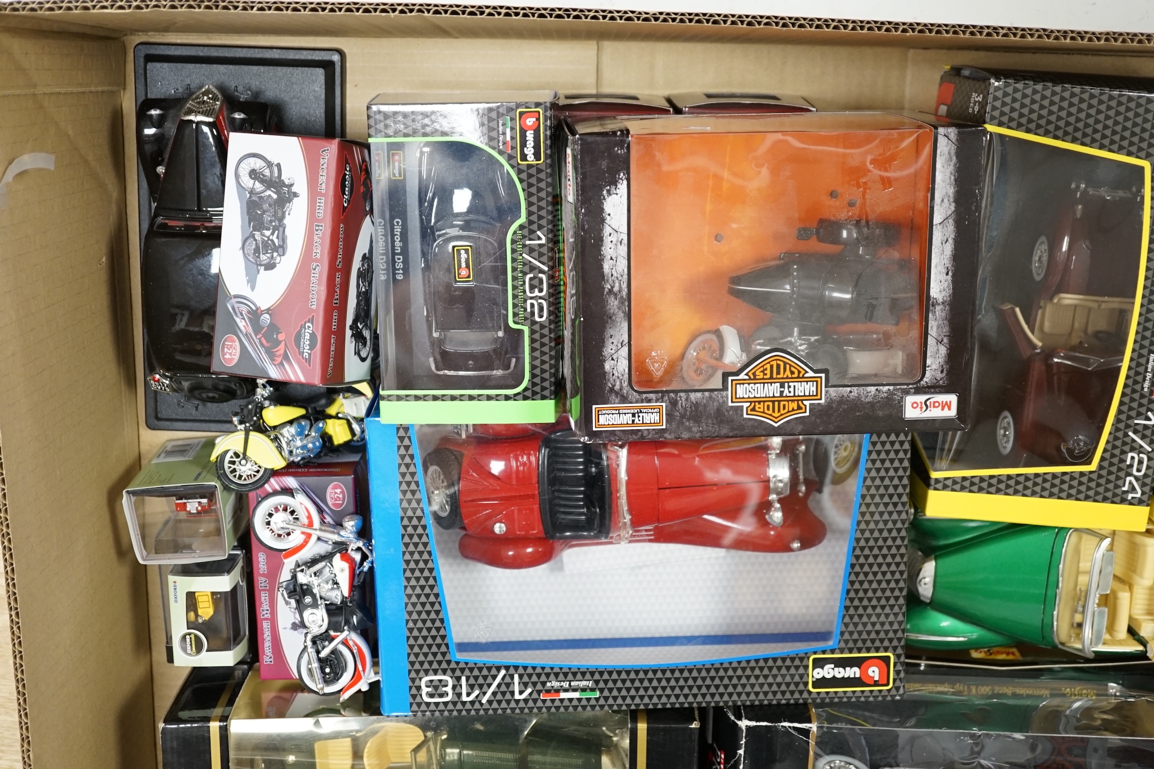 A quantity of diecast vehicles, including Burago, Harley Davidson, Maisto, etc. Condition - varies